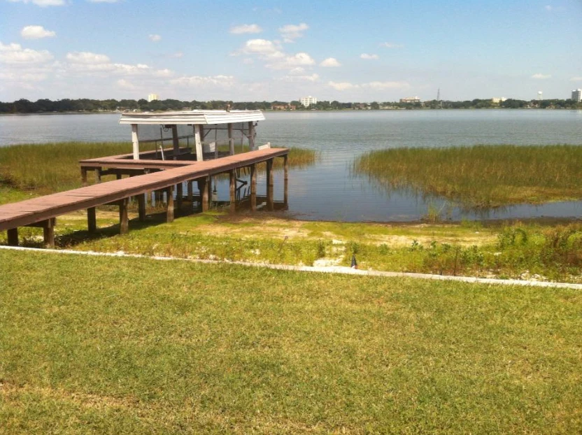 A wooden dock with a covered boat lift on Lake Howard, part of Winter Haven's Chain of Lakes